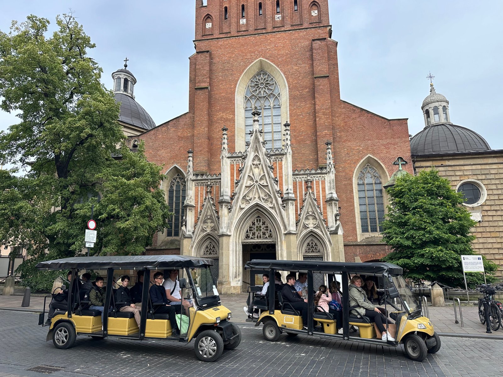 Tourists riding in a golf cart in Kraków