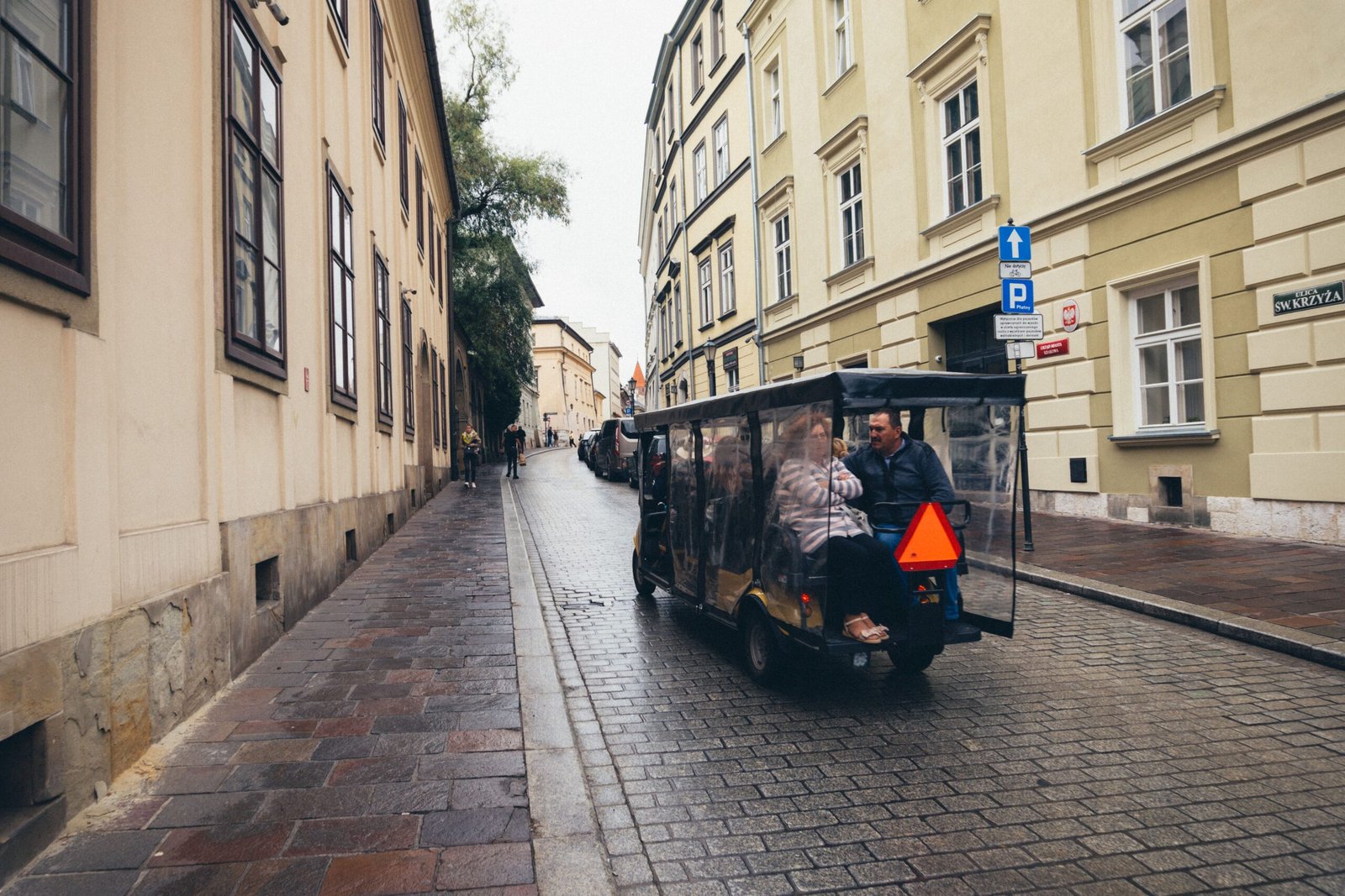 Tourists riding a golf cart tour through Krakow